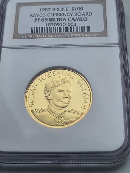 картинка Бруней. 100 Долларов 1987 г. Золото. 13.5 г*0.917 0.398 oz. СЛАБ NGC PF 69 ULTRA CAMEO! от магазина Одежда+ 3